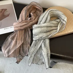 Detailed view of plisse tie-dye skinny scarves with wavy edges and striped textures