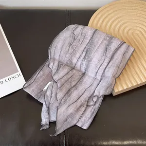 Detail of light purple tie-dye stripe scarf with marble texture on black leather surface