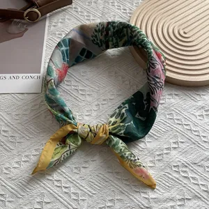 Detailed view of luxury silk scarf with oil painting floral pattern and satin finish