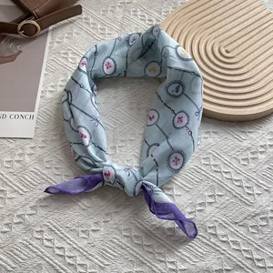 Detailansicht eines vintage hellblauen Seidentuchs mit handgerollten Kanten und Blumen