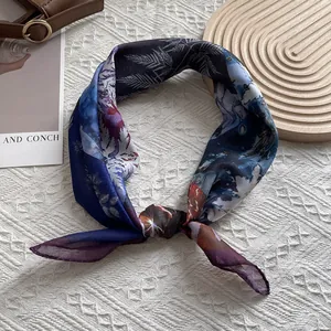 Detail of silk scarf with abstract patterns in blue and purple on a textured tray