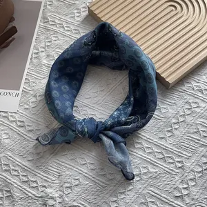 Detail of blue paisley cotton silk scarf with vintage floral patterns for hair or neck