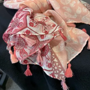 Detail of bohemian paisley cotton scarf with delicate pink fringe and soft texture