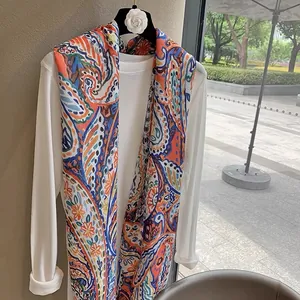 Ethnic paisley pattern shawl wrap for women in vibrant orange and blue lightweight fabric
