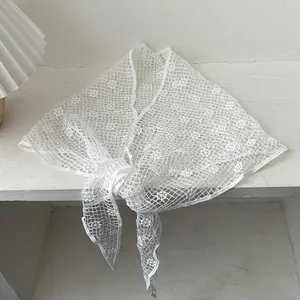 Elegant white lace hollow knit sunflower shawl scarf in a minimalist triangle design