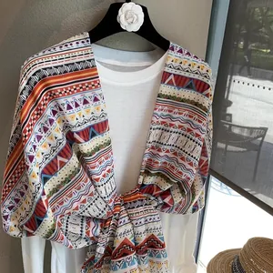 Bohemian style long scarf with colorful geometric patterns and decorative tassels