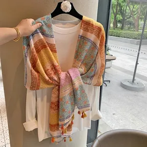 Bohemian paisley print scarf with colorful floral patterns and decorative tassel edges