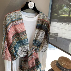 Detail view of lightweight bohemian printed shawl with tassels and ethnic floral patterns