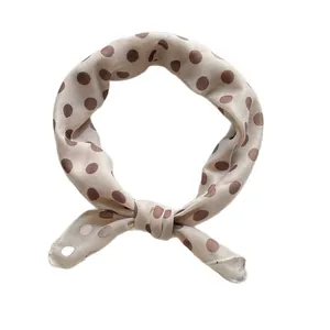 Retro polka dot silk scarf in beige and coffee brown, tied in a stylish ring knot