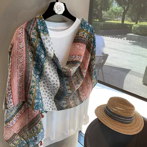 Detail of bohemian printed shawl with ethnic floral patterns and tassel trim edges