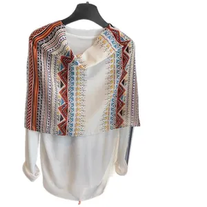 Women's knit sweater and bohemian geometric shawl with colorful zigzag patterns