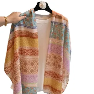 Colorful floral bohemian long scarf with tassels shown as a lightweight beach shawl