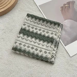 Green and white geometric patterned cotton square scarf with retro heart motif flat lay