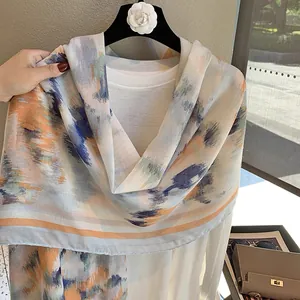 Detail of artistic watercolor linen scarf with morandi tones and elegant draping