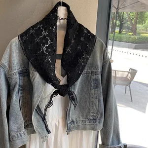 Floral black lace shawl accessory styled over a blue denim jacket on a mannequin