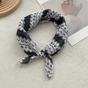 Detailed view of a retro geometric pattern cotton scarf with chic black and white motifs