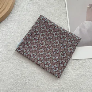 Folded vintage cotton linen square scarf with blue and brown floral geometric pattern