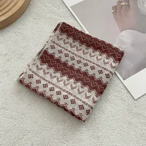 Close-up of heart jacquard pattern on cotton scarf with detailed retro embroidery