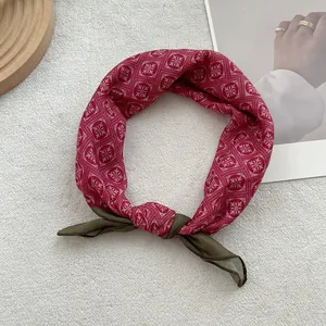 Close-up of vintage floral cotton linen scarf with geometric patterns and satin finish