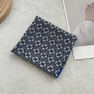 Detailed view of dark floral cotton linen scarf showing premium fabric texture and stitching