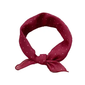 Classic burgundy polka dot neck scarf tied in a stylish knot on a white background