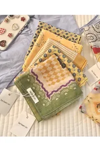 Close-up of retro floral cotton scarfs with vintage geometric patterns and paper tags