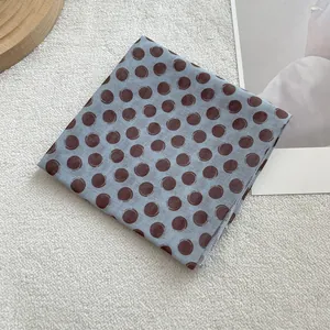 French vintage blue cotton linen square scarf with brown polka dots on white plush background