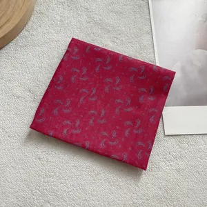 Detail view of pink paisley pattern square scarf with elegant floral prints