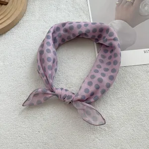 Detail of light pink polka dot cotton linen scarf with fine stitched edges and soft texture