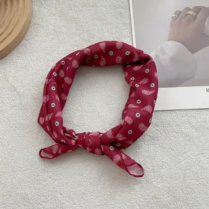 Close-up of wine red paisley print cotton linen small square scarf tied as hair accessory