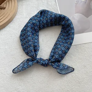 Close-up of retro floral pattern on navy blue square cotton linen scarf with fine stitching
