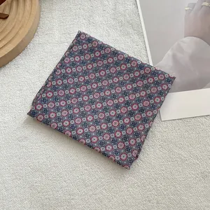 Close-up of floral cotton linen square scarf with red and blue geometric patterns