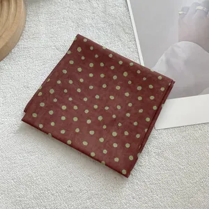 Detailed macro shot of vintage soft cotton linen square scarf with polka dot pattern