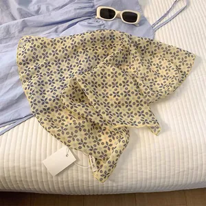 Detailed view of floral printed cotton linen scarf with fine yellow stitched edges