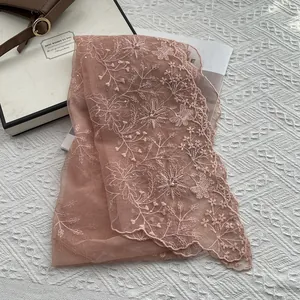 Detail of dusty rose lace scarf with floral embroidery, pearls and scallop edges