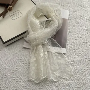 Elegant off-white lace scarf with floral embroidery and scalloped edges in a gift box