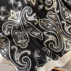 Close-up of black and cream paisley print fabric with high density weaving and fine texture
