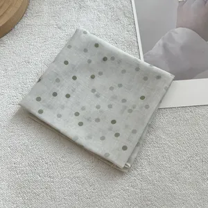 Detail of vintage French polka dot scarf showing linen texture and neat edge stitching