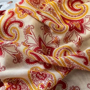 Detailed close-up of paisley pattern scarf showing smooth texture and drape