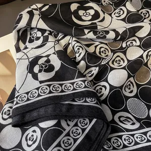 Detail shot of camellia pattern scarf with premium silk texture and floral borders