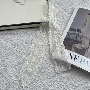 Elegant white lace floral embroidery narrow scarf displayed on an aesthetic background