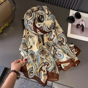 Detail of elegant paisley scarf with silk texture and vintage pattern for women