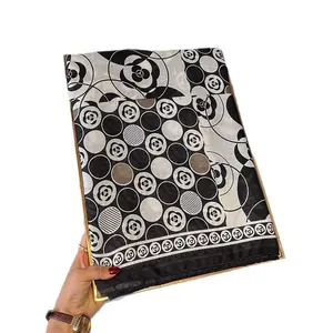 Elegant camellia print cotton linen scarf in black and white with a golden display tray