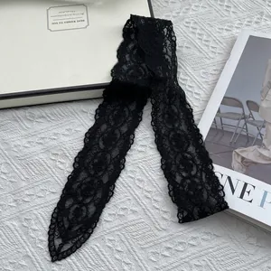 Detail of black lace narrow scarf with vintage rose floral texture and pointed ends