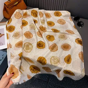 Elegant beige cotton linen scarf featuring yellow polka dots and subtle gold sequins
