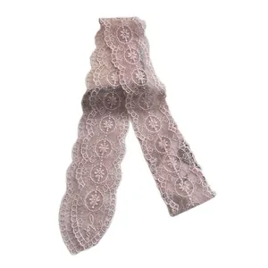 Pink lace embroidered flower scarf with wavy edges and elegant lettering on white background