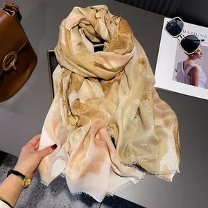 Elegant beige cotton linen scarf with gold foil floral print and frayed edges