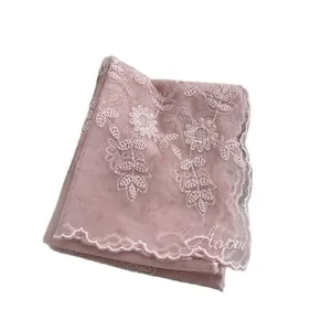 Pink lace scarf with sunflower embroidery and scalloped edges for elegant hair styling