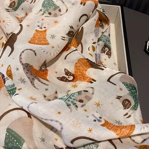 Off-white cotton silk scarf featuring cute cartoon cat prints and festive snowflakes