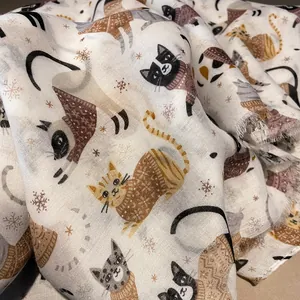 Close-up of soft cat print scarf featuring cute winter kittens and fringe edges